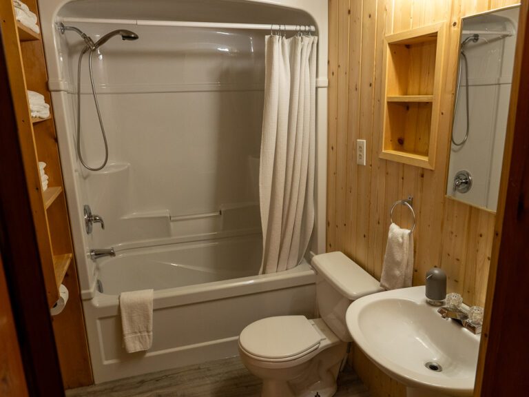 Cottage bathroom, showing shower/bath with sink and toilet