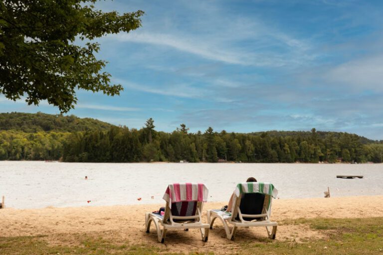 Two Muskoka chairs on a beach