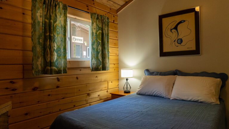 Cottage bedroom with lamp on in corner