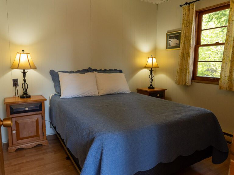 Large bed in cottage bedroom