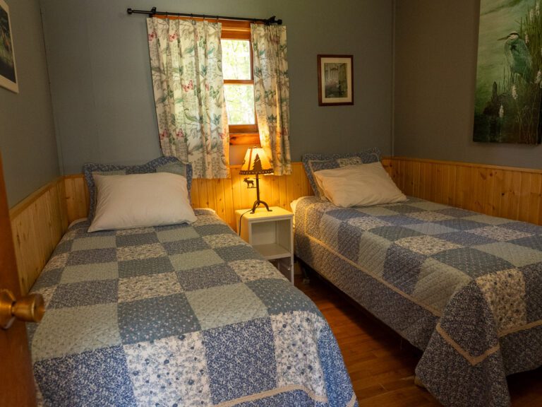 Two single beds with lamp in between