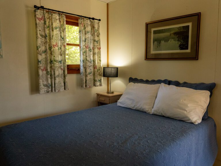 Large bed in cottage bedroom