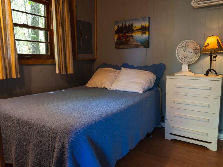 Cottage bedroom with curtains open