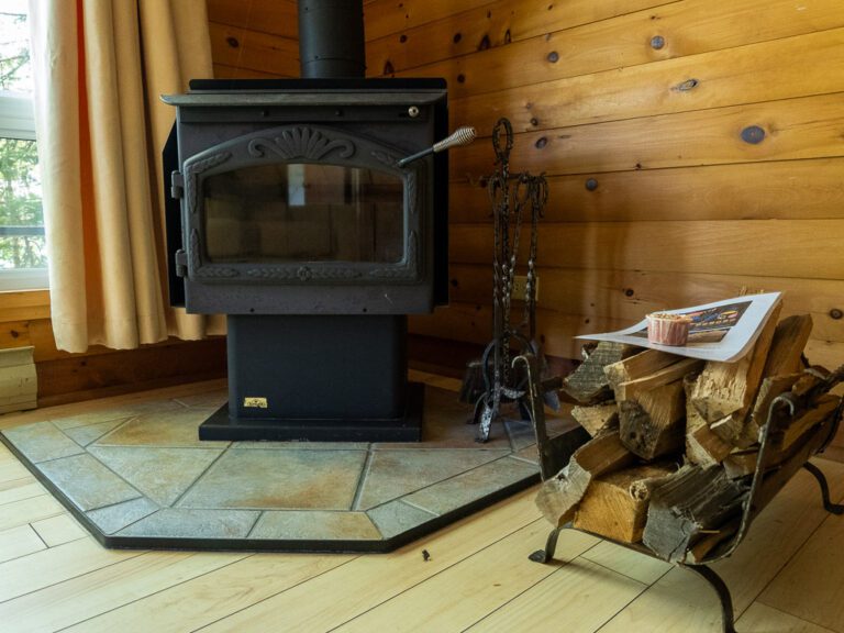 Cottage fireplace with firewood stacked beside it