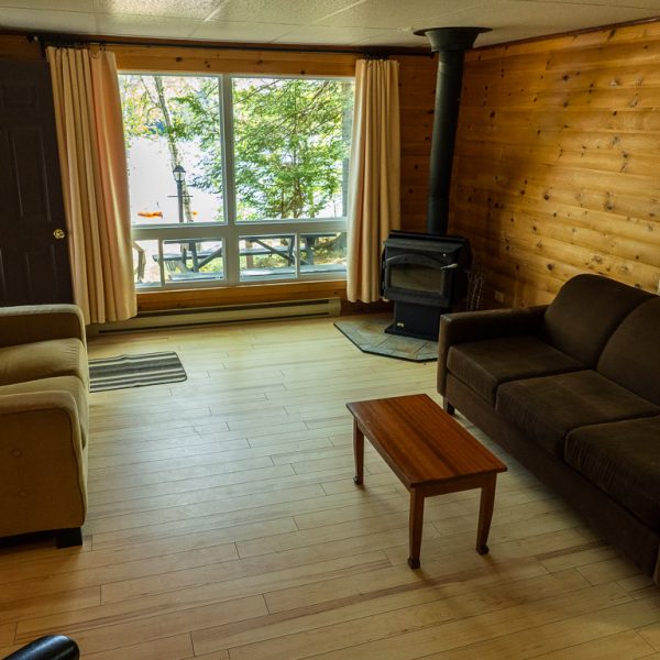 BBM09953_Cottage-9 View of cozy cottage living room, looking towards fireplace and large windows